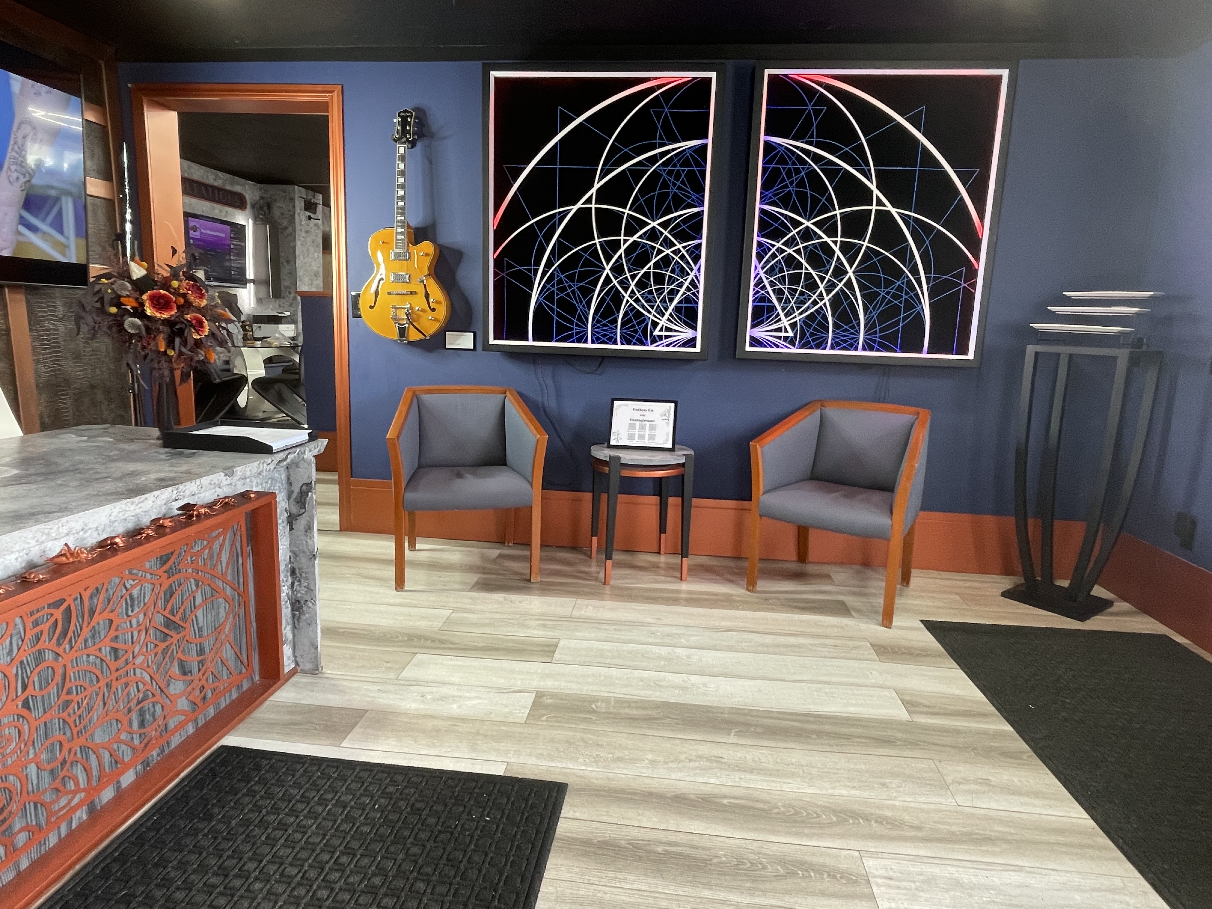 Magic Circle Tattoo Studio Waiting Area - Bay City Michigan Professional Tattoo Shop with Modern Geometric Art and Comfortable Seating